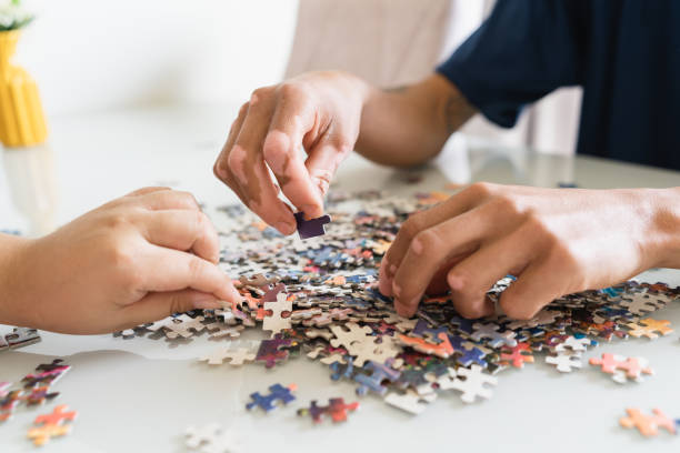 istock Detail of hands looking for puzzle pieces 1424026209