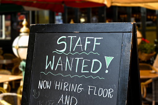 Staff wanted recruitment sign outside a restaurant in Europe. No people.