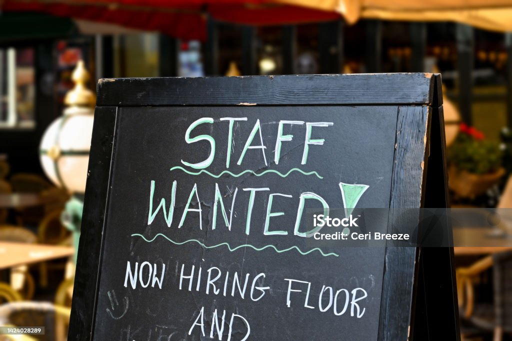Staff wanted sign outside a restaurant Staff wanted recruitment sign outside a restaurant in Europe. No people. Help Wanted Sign Stock Photo
