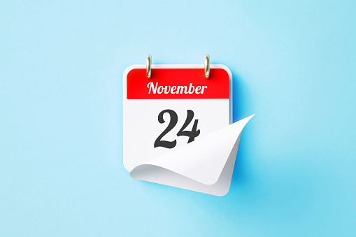 November 24 written red calendar sitting on blue background. Horizontal composition with copy space. Directly above. Thanksgiving concept.