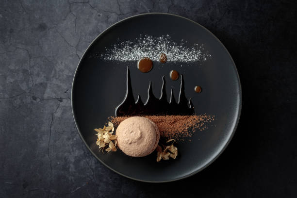 istock Macaroon on a black plate garnished with chocolate sauce and cocoa powder. 1424032243