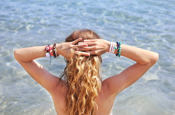 istock model advertises greek jewelry on the beach 1424032986