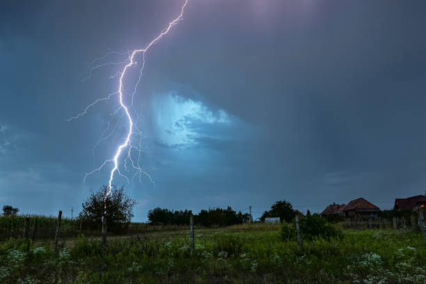 istock Thunderbolt of lightning strikes down in a rural landscape 1424034377