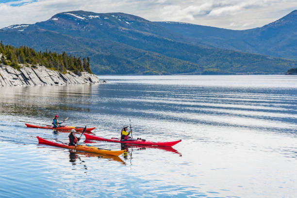Tourists are playing Kayak at Neddy Harbour, Norris Point, Newfoundland and Labrador, Canada.