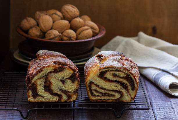 istock Traditional Easter bread with chocolate and nut filling on a wooden background. 1424038324