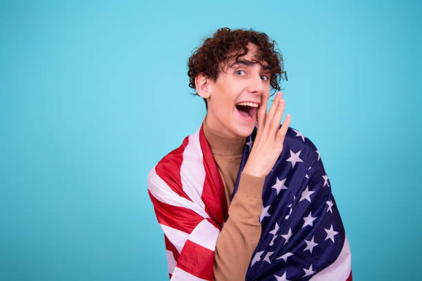 istock Young attractive guy with a flag posing in the studio. 1424041591
