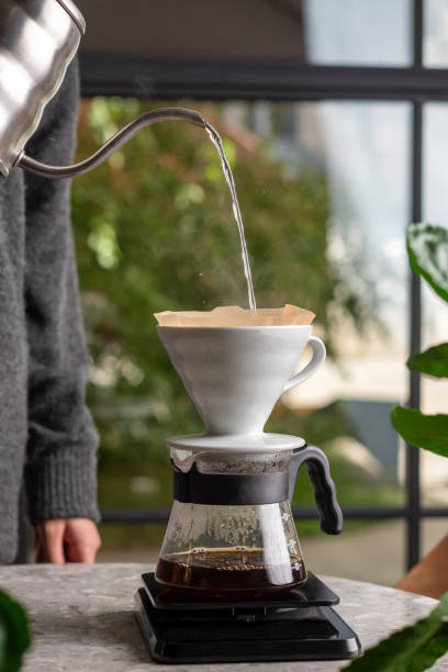 istock Barista is making drip brewing, filtered coffee, or pour over coffee with hot water and filter paper in coffee shop 1424042285