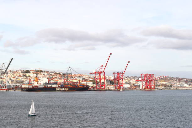 Lisbon, Portugal - February 16, 2022:  A view of the port of Lisbon in Portugal with the container ship, Sounion Trader docked on the Tagus River.
