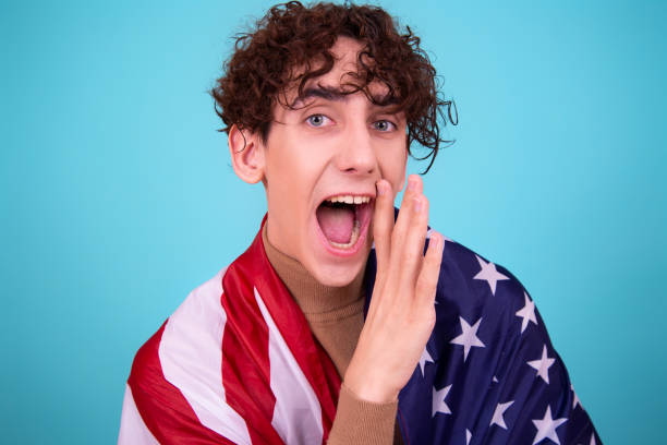 istock Young attractive guy with a flag posing in the studio. 1424042505