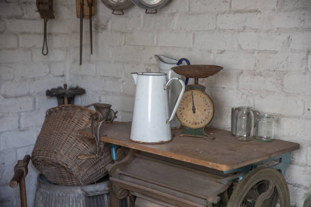 istock Old style utility kitchen with scales, jug, wicker basket - Victorian kitchen with old equipment. 1424042875