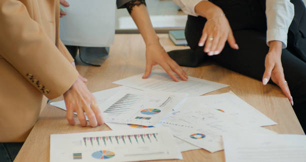 istock Womens hands working together signing documents on a desk in office. 1424043403