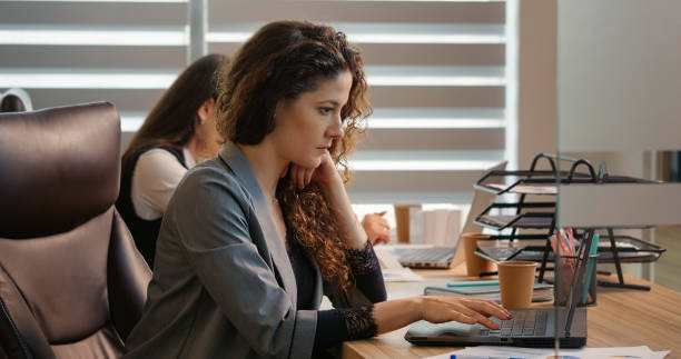istock Caucasian business woman working at computer in office. 1424043472