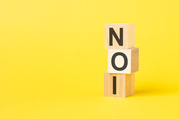 istock NOI - text on wooden cubes, on yellow background 1424044619