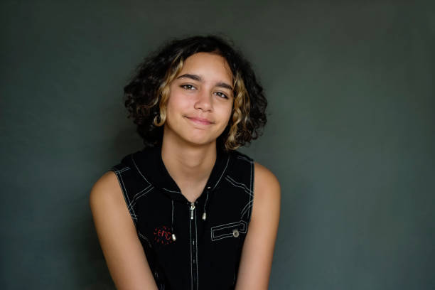 Portrait of a mixed-race non-binary teenager in studio. stock photo