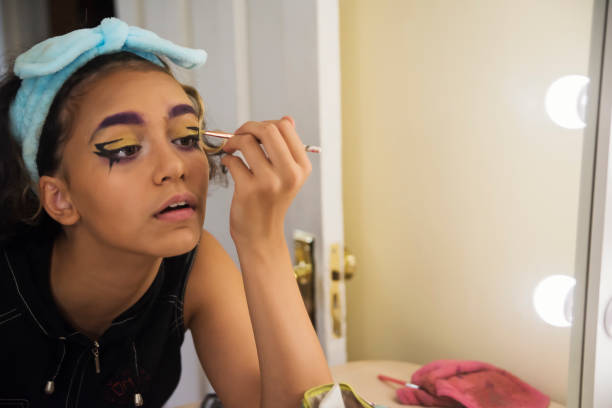istock Mixed-race non-binary teenager in make-up session. 1424047499