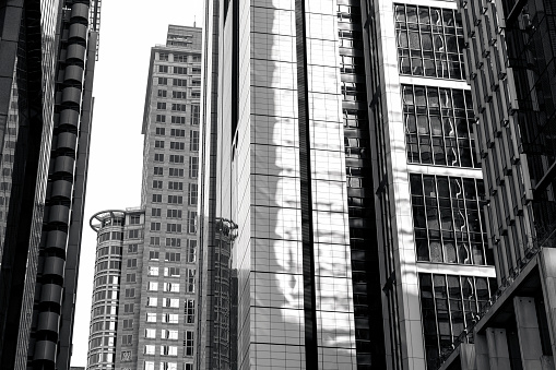 Black and white low angle view of modern corporate buildings skyscrapers, CBD Sydney Australia, background with copy space, full frame horizontal composition