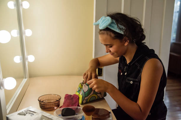 istock Mixed-race non-binary teenager in make-up session. 1424048569