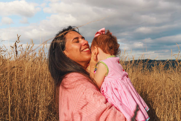 Latin woman hugging her little daughter