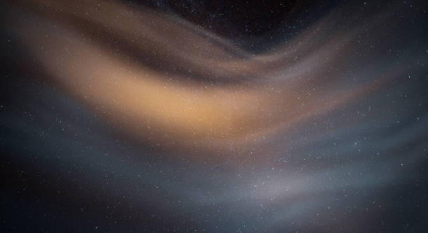 Night sky background with clouds and stars.