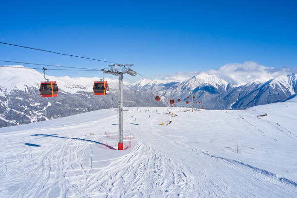 Ski lift in the snowy mountains of Arkhyz resort city in Russia stock photo
