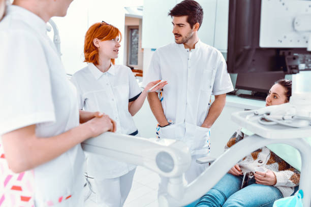 istock Dental Team Discussing Upcoming Surgery For Patient 1424059110