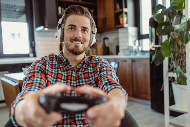 istock Portrait of a young man playing video game 1424059203