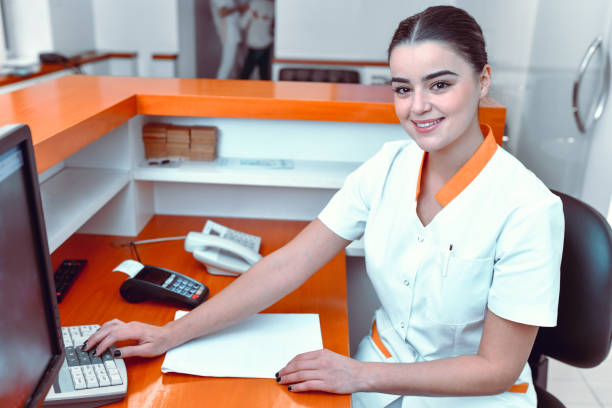 istock Beautiful Smiling Dental Nurse At Her Work Place 1424059419