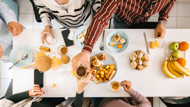 istock High angle view of a breakfast table with people 1424060536