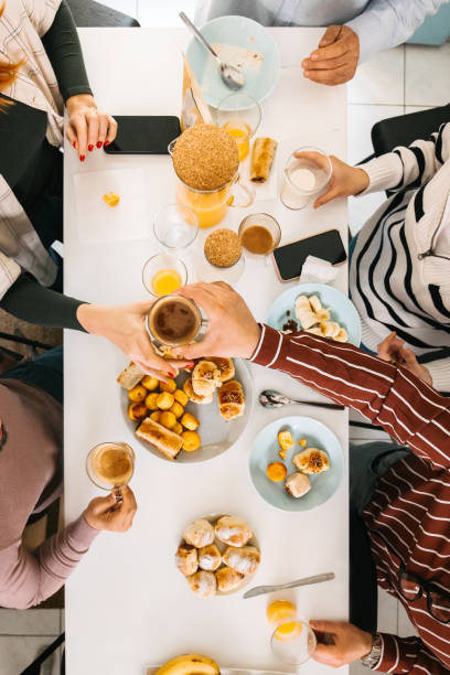 istock High angle view of a breakfast table with people 1424060555