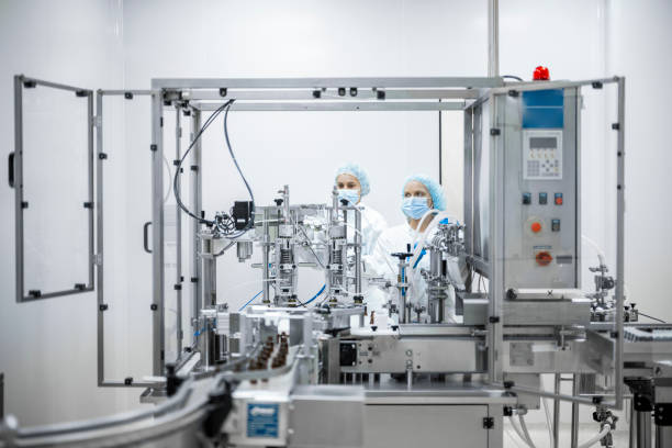 istock Two fully equipped coworkers in protective workwear seen in a pharmaceutical laboratory 1424064053
