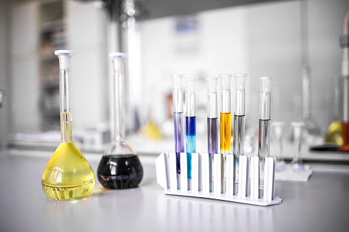 A few chemical bottles and test tubes seen in a laboratory with all other equipment during some pharmaceutical research.