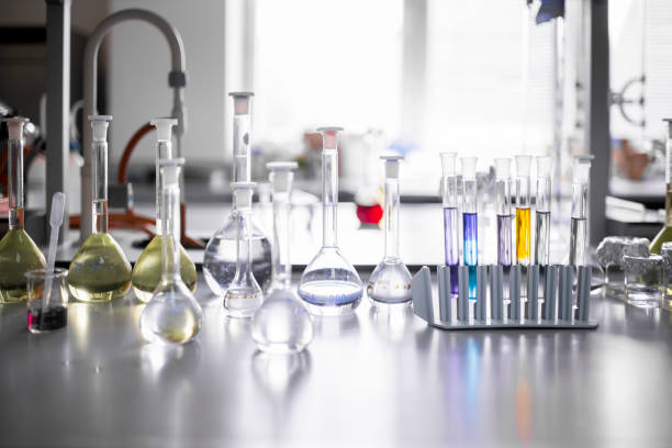 two clear beaker with water in chemical science laboratory research with molecular structure background