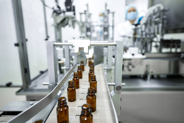 istock Two female employees in a pharmaceutical laboratory seen while controlling the process of drugs manufacturing 1424064346