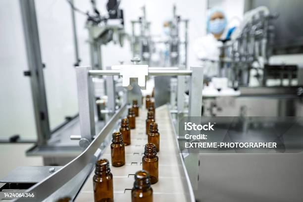 Two Female Employees In A Pharmaceutical Laboratory Seen While Controlling The Process Of Drugs Manufacturing Stock Photo - Download Image Now