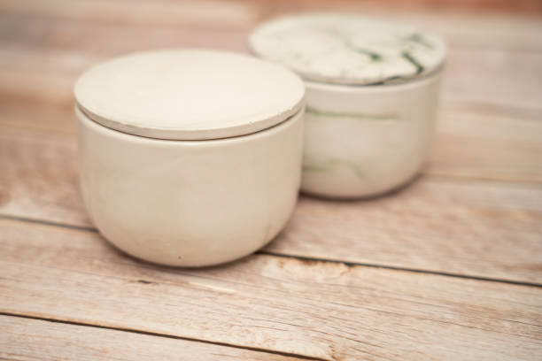 istock Two candles with lid on a wood table 1424069604