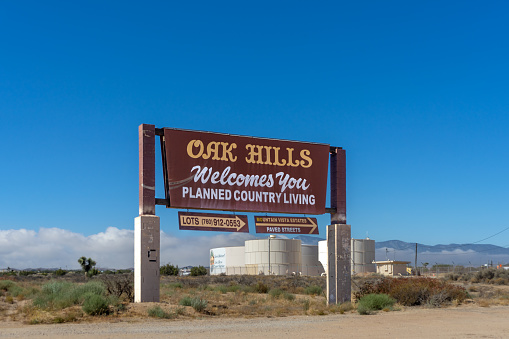 Oak Hills, CA, USA – September 14, 2022: Old welcome sign Mountain Vista Estates planned country living community in the rural area of Oak Hills, California.