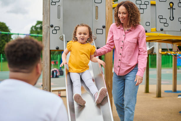 istock family playing on a play slide 1424079744