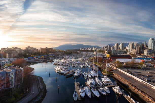 View of Vancouver City in False Creek, BC, Canada View of Vancouver City in False Creek, BC, Canada. Sunny Cloudy Day. Modern Cityscape, Granville Island, residential homes, marina and buildings. Sunset Sky Art Render granville island stock pictures, royalty-free photos & images
