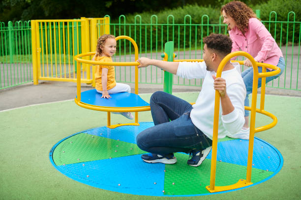 istock family playing on a roundabout 1424081646