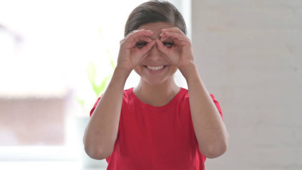 istock Indian Woman Searching with Handmade Binocular 1424088445