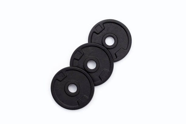 istock Black weight plates on white background. Gym equipment 1424089519