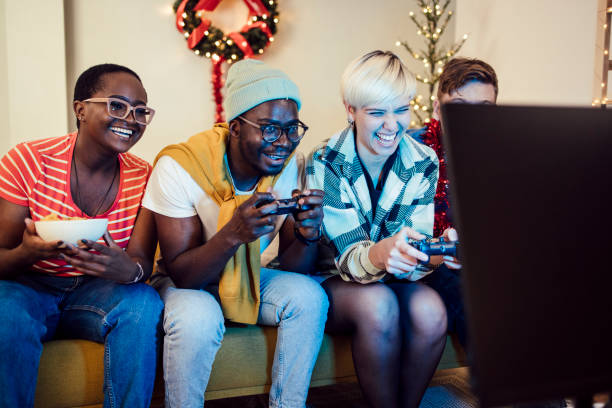 istock Group of students gaming on a New Year's Eve 1424097656