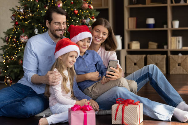 istock Cheerful two kids and parents talking on video phone call 1424097699