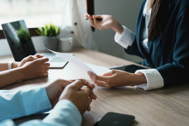 istock Couples consult with a representative to plan an insurance contract 1424097780