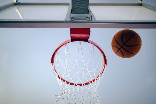 Close-up of basketball reaching to hoop