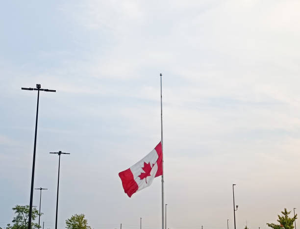 istock Canadian Flag at half mast 1424100459