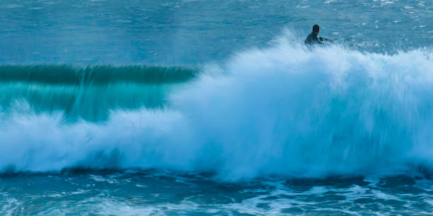 istock Satin Sunrise, wave and surfers 1424111920