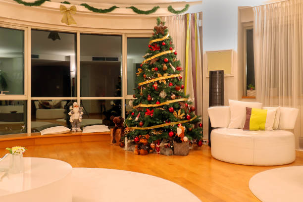 Home living room be decorated for a merry Christmas and happy New Year concept with snow visible outside of window ready for gifts to go under the tree