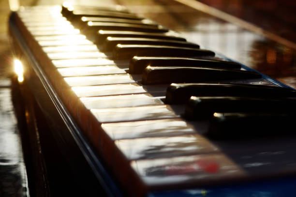 Piano and sunset The piano that looks sparkling under the sunset light grand piano stock pictures, royalty-free photos & images