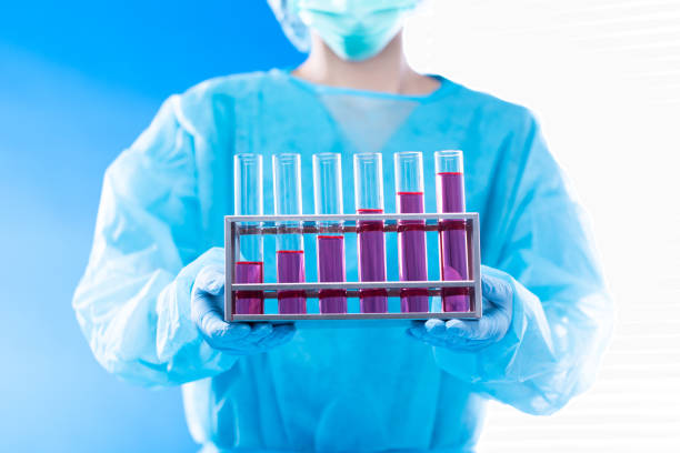 Lab assistant uniform with mask gloves holding test tube with science laboratory research sample while analyzing development on biology chemical as graph growth increase investment revenue, copy space